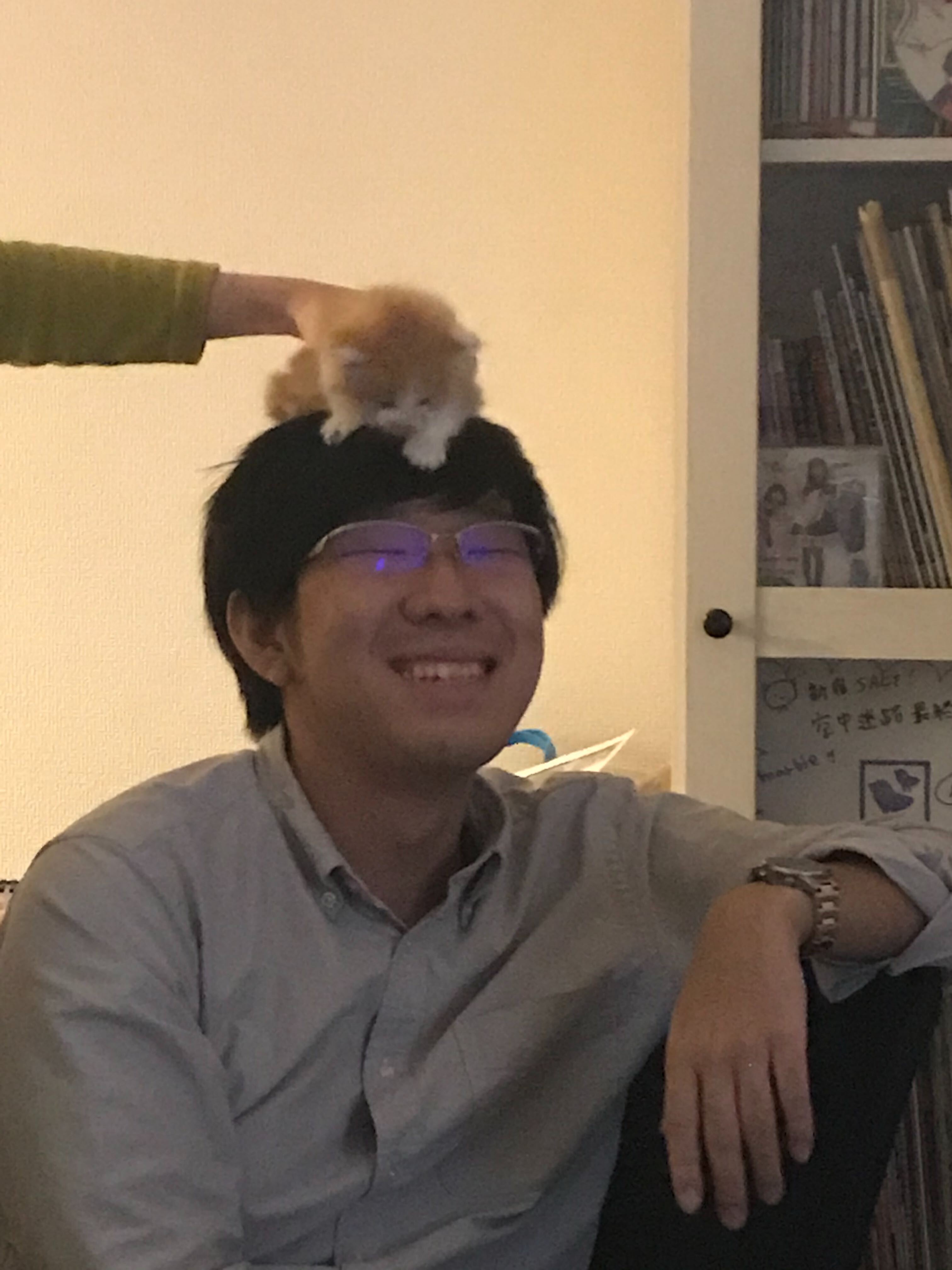 Daiki Nishiyama with a kitten on his head